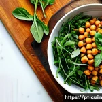 Home 21 식물성 단백질로 풍미를 더하는 요리 - A vibrant, rustic kitchen scene featuring a colorful Mediterranean salad bowl filled with cooked chi...